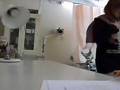 Buxomy Japanese minx got her beaver fucked with a toy at a gyno