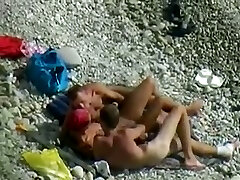 Sexy female and two kinky dudes enjoy foreplay on the beach when I spy them