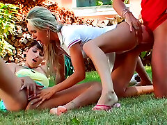 Two awesome gals get busy with sucking a firm fat cock right in the yard