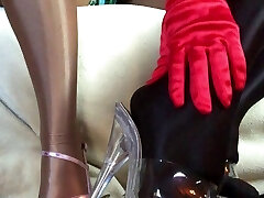 Sensual teasing close up legs and feet in Shiny glossy stocking and high heels.