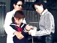 The two lesbian Japanese guards bring a poor guiltless girl.