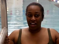 Plus-size Black woman put a pink latex swimcap