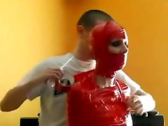 Mummified Bondage Babe In Red Tape