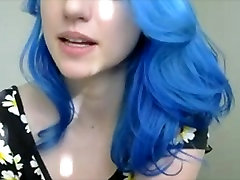 Blue haired girl in flowers plays with tits