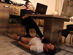 Foot slave lies under the table
