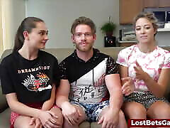 Three friends are playing strip basketball indoors with high stakes