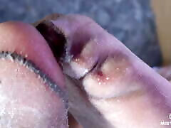 Foot slave licks and sucks Mistress&039;s feet in lubricated flesh-colored pantyhose
