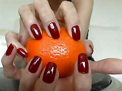 Fruits and Beautiful Hands with Red Fingernails