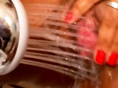 Mulatto woman pissing with big breasts while showering