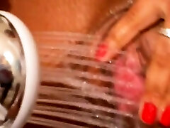 Mulatto woman pissing with big breasts while showering