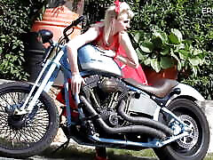 German blonde camgirl dangles her boobs on the motorcycle, and after that she makes a show at EroticOnly!