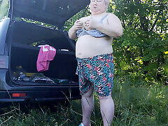 Mother-in-law masturbates her pussy in nature