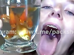 Evil white woman devours live fish in bathroom - vore giante