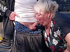 A neighbor holds my dick while I pee and then sucks it in public