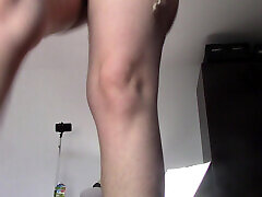 Amateur woman has fun trying on clothes and cutting them.
