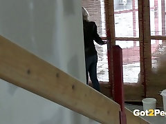 Dirty blond chick in heeled shoes pisses at house which is in the course of building