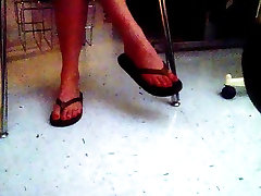 Girl dangling big kiss ass flops in the dark