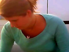 Woman with low d.collet. leans forward and shows downblouse