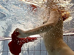 Sensual red haired babe teen lizle bell shows striptease under the water