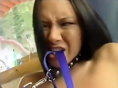 Submissive brunette on a leash gets pounded in both holes by her man