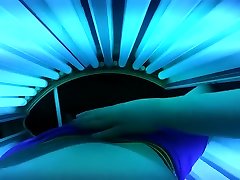 Woman strokes me while laying in a Tanning Bed