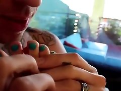 Attractive couple shares a bowl of berries in bed