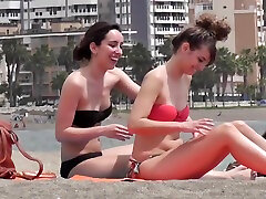 Two topless girls on beach