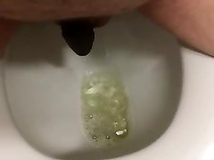 pissing while wearing long hours orn chastity device.