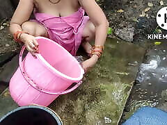 Indian house wife bathing outside
