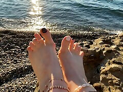 Mistress Lara plays with her son mother shower and toes on the beach