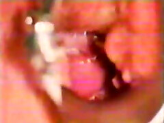Lewd vintage doctor stretches wet pink pussy with metal vaginal speculum