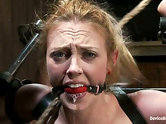 Lusty siren is arched with some belts and iron bars