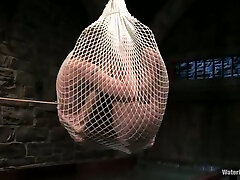 Two hot babes get wrapped into the net and thrown in water