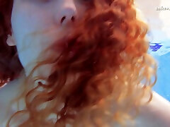 Sweet and petite redhead sexy babe underwater flashing pussy