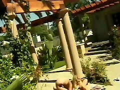 Two attractive kinky lesbians fucking outside on towel