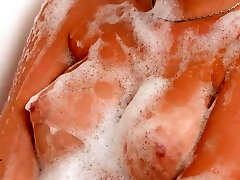 Enhanced babe Sharon White takes a luxurious feel the tidy bath