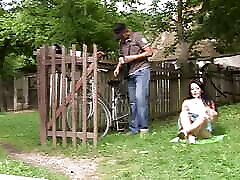 Dark haired slut with small tits taking a loaded bone outdoors